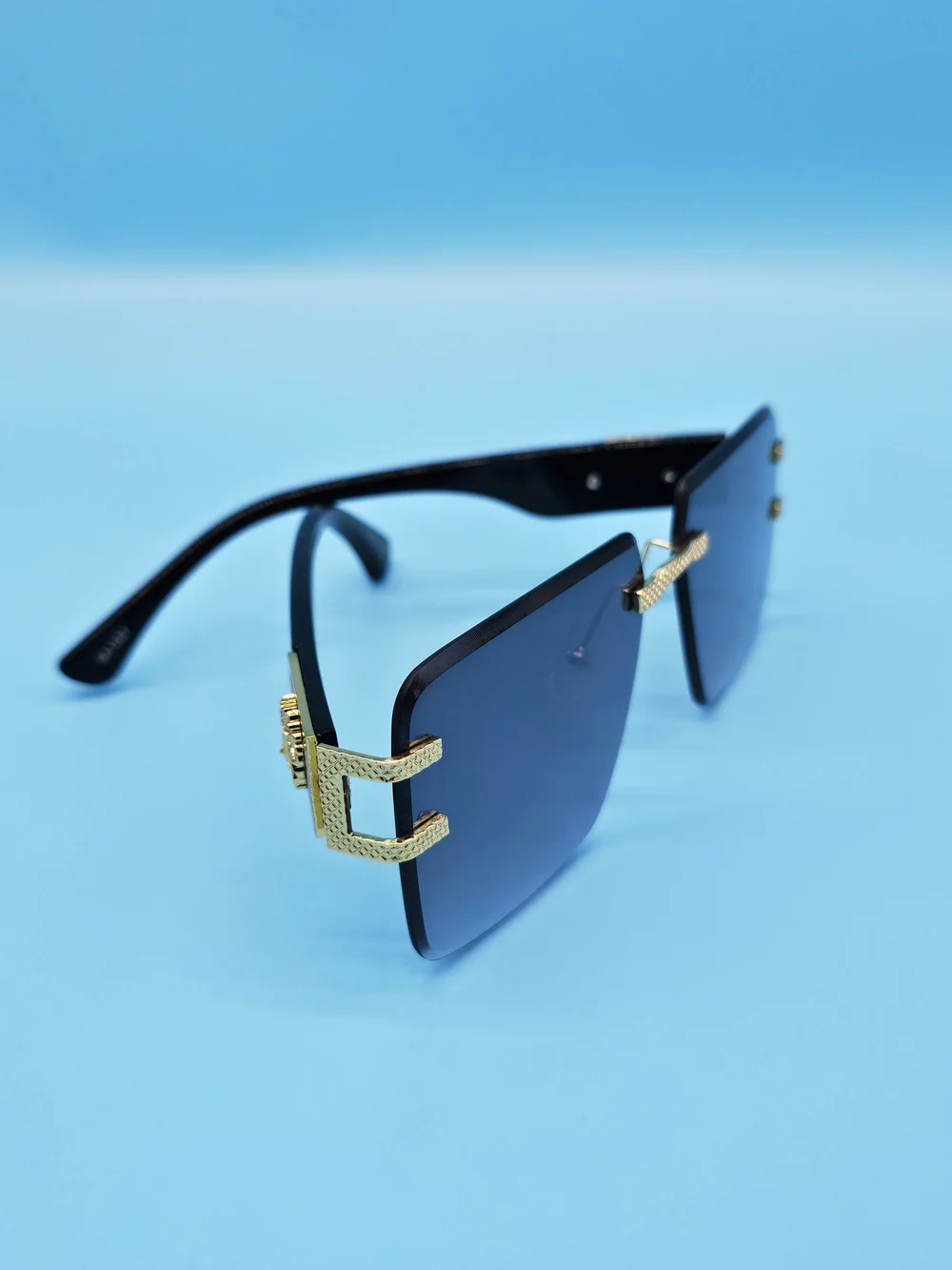 Gold-Trim Black Sunglasses with Dark Lenses